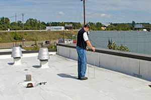 Photo 2 showing worker conducting the low voltage test on a rooftop