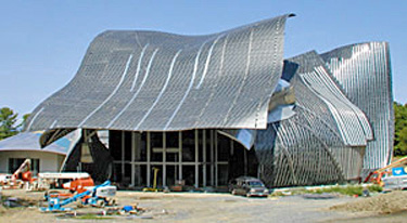 Photo 7 showing building with curved roof composed of multiple metal components